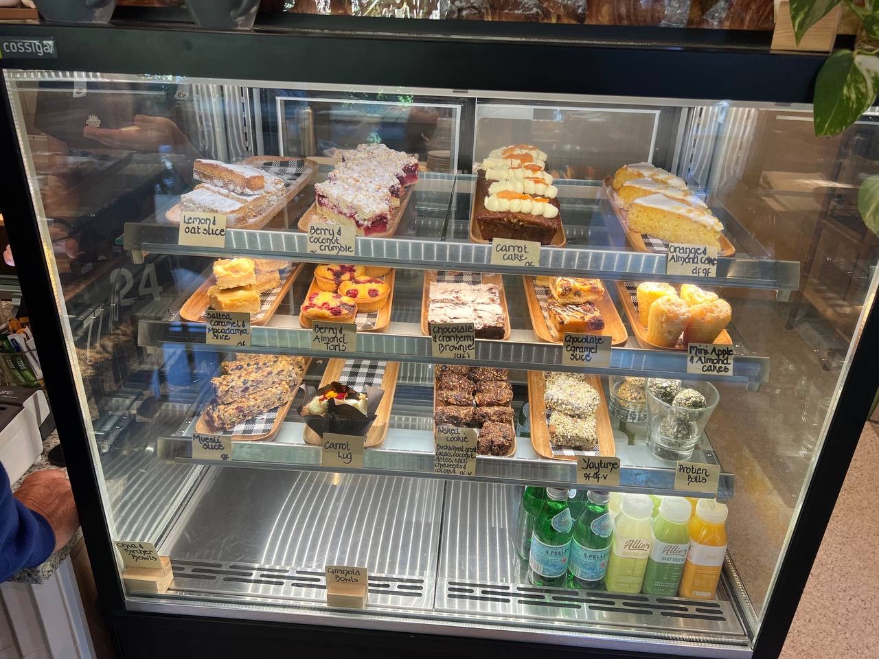 A fully stocked cabinet of sweet treats at Sunshine Social