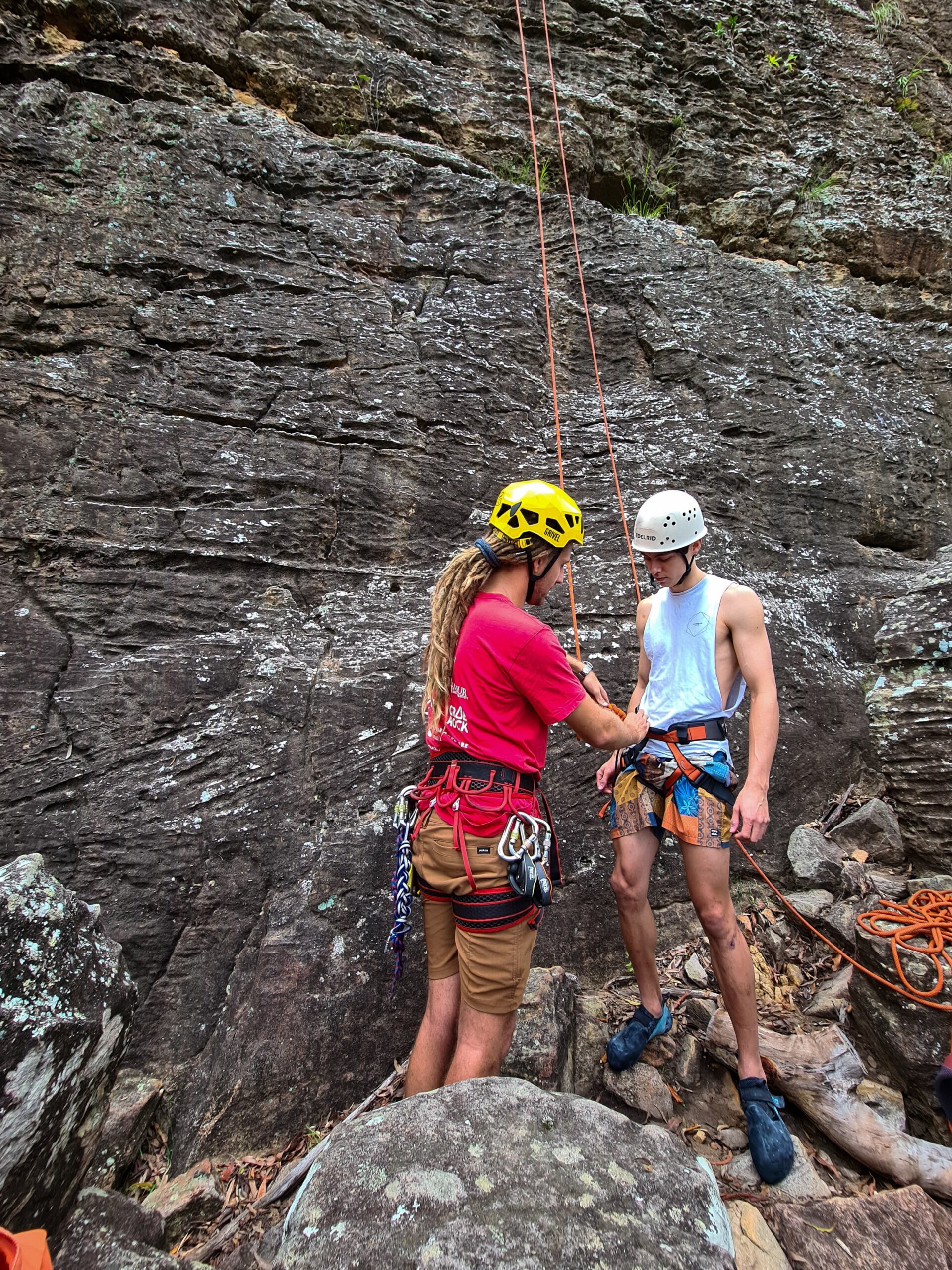 Safety check of the harness at the bottom of the rock face